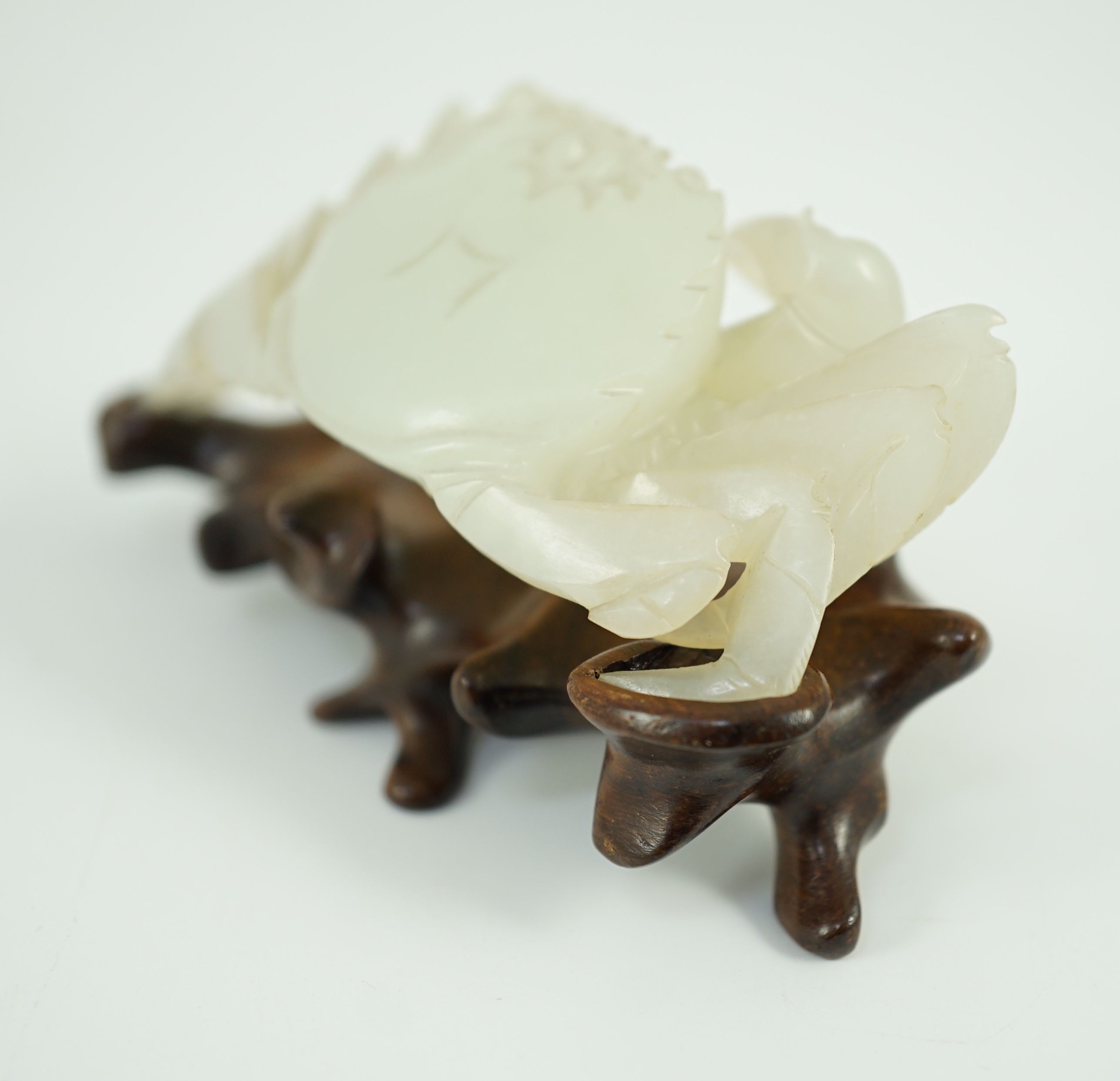 A Chinese pale celadon jade model of a crab, 20th century, 8.4 cm wide, wood stand